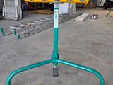an image of a green and yellow machine in a warehouse