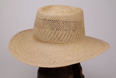 une image représentant un chapeau de paille posé sur une tête de mannequin