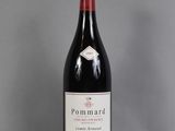 a bottle of red wine sitting on top of a table