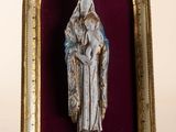 an image of a statue of a woman holding a baby in a gold frame