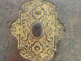 a close up of a metal plate with a decorative design