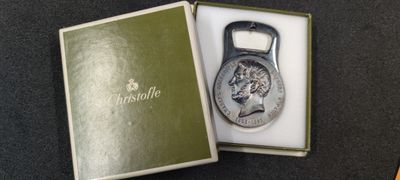 a bottle opener that is in a box on a table