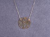 a silver necklace with a circular design on a chain