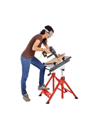an image of a woman using a power saw to cut a piece of wood