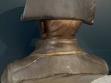 statue of a man wearing a hat on a marble table