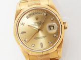 an image of a gold rolex watch on a white surface