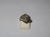 a close up of a silver ring on a white surface
