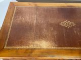 a wooden table with a brown leather cover on it