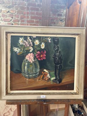 a painting of a vase of flowers on a easel
