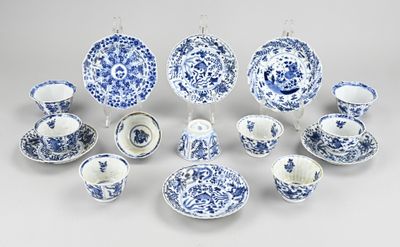many blue and white plates and cups and saucers