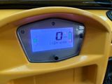 a yellow car with a digital display on the dashboard