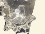 a glass bowl with a pipe in it on a table
