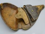 an old leather case with a metal handle and a key in it