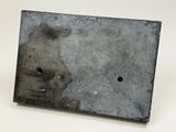a metal plaque with a hole in the middle of it