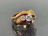 an image of a gold ring with two diamonds on top of it