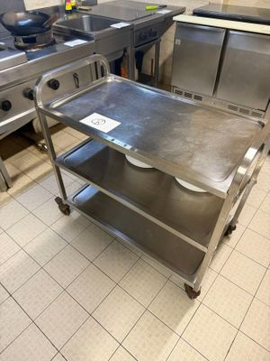 a stainless steel table in the middle of a kitchen