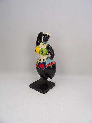 figurine of a black and white bird with a red heart on it ' s chest