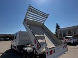 a white dump truck parked in a parking lot