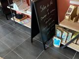 a blackboard in the corner of a store with a chalk board on the floor