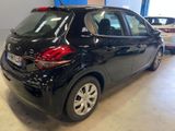 the back of a black car in a showroom with other cars in the background