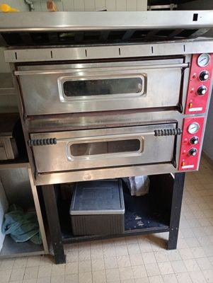 three ovens stacked on top of each other in a kitchen