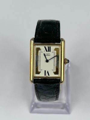 an image of a gold and black watch with roman numerals