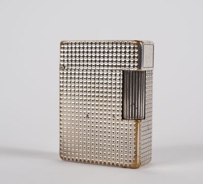 a silver lighter sitting on top of a white surface