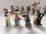 many figurines of people that are standing on a table