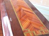 a wooden box with a design on it sitting on a table