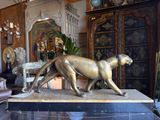 a statue of a cat that is on display in a room