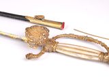 two swords and a cane on a white surface