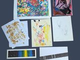 a lot of art work on display on the table