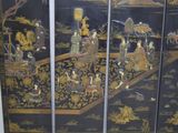 an image of a black and gold screen with people on it