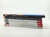 three books stacked on top of each other on a white surface