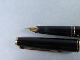 two pens sitting next to each other on a table