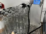 Des bouteilles d'eau sont alignées sur une machine dans une pièce
