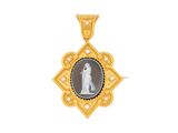 a close up of a gold pendant with a picture of a woman