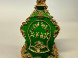 an image of a green and gold vase with a crown on top
