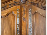 a close up of a wooden armoire with a metal handle