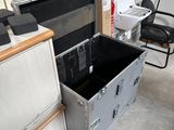 a tv sitting in a metal case in a room