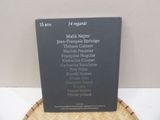 a plaque on a table that has a list of people on it