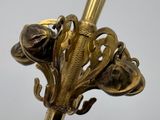 a close up of a gold colored umbrella with a flower on it