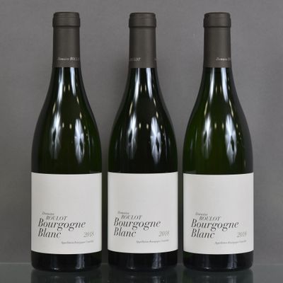 three bottles of wine sitting on top of a table next to each other
