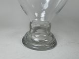 a clear glass vase with a clear base on a table