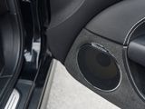 a close up of a car door with a speaker in it