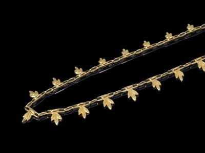 le bandeau est orné de feuilles dorées et de perles
