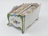 a small white box with a bunch of cups in it