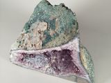 a piece of rock that has a purple and green substance on it