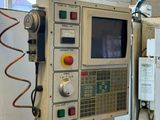 a machine that is working on a piece of wood
