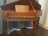 a piano that is sitting on a wooden table